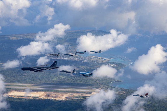 A U.S. Air Force (USAF) B-52 Stratofortress aircraft is flanked, from left to right, by a U.S. Navy E/A-18 Growler, Japan Air Self-Defense Force (JASDF) F-2, JASDF F-15MJ, USAF F-16CM, JASDF U-125A, USAF F-16CM, USAF F-15C, JASDF F-2, and a U.S. Marine Corps F/A-18 Hornet aircraft during a multinational formation flight over Tinian and Saipan, Feb 6, 2024. Allies and partners during the multilateral exercise, Cope North 24, trained together to improve shared tactics and multilateral defense capabilities. (U.S. Marine Corps photo by Sgt. Jose Angeles)