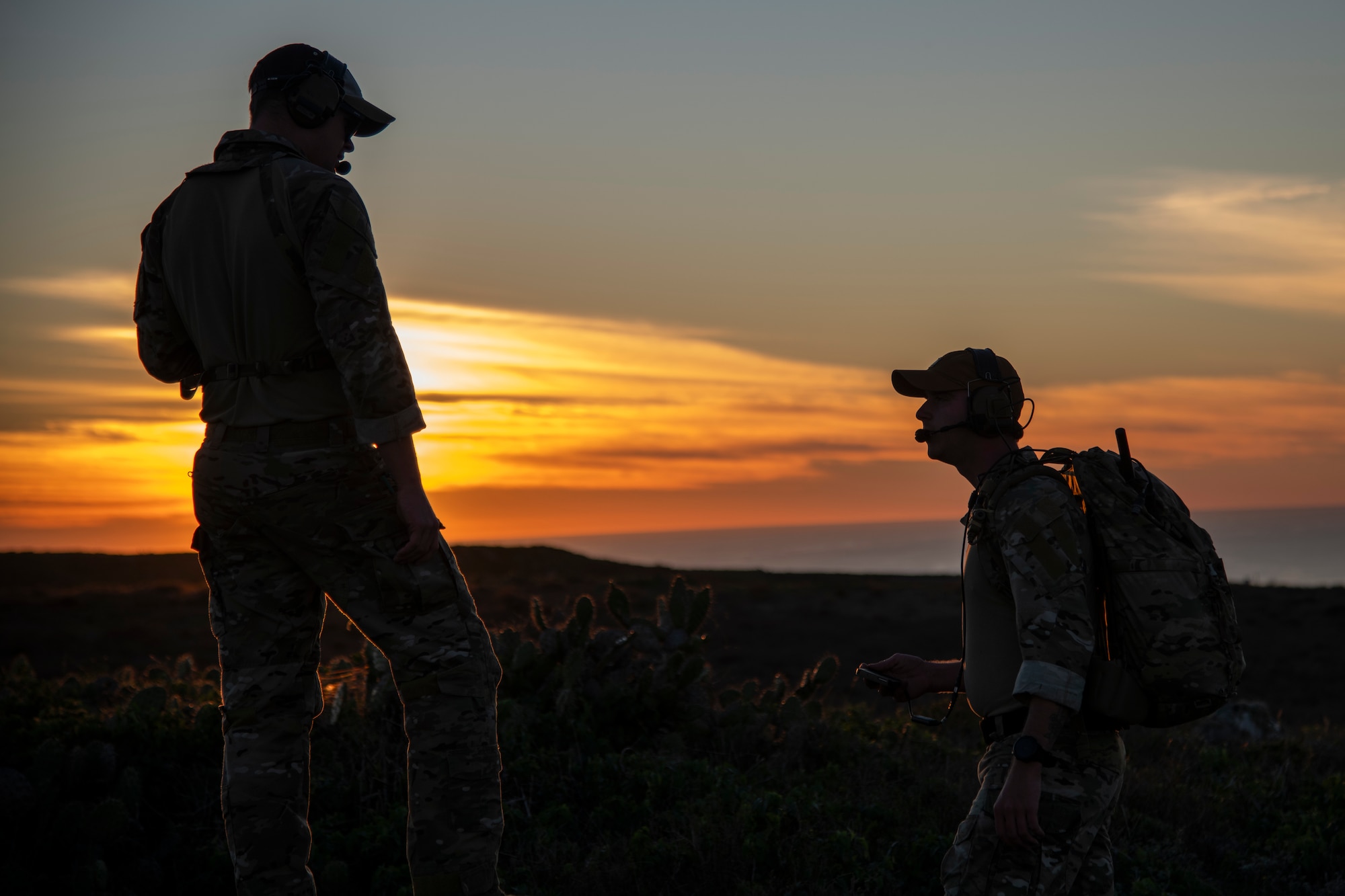 Airmen talk during sunset