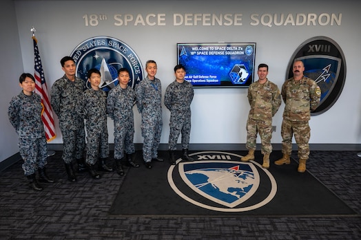  Operators from the Japanese Air Self-Defense Force, Space Operations Group, 1st Space Operations Squadron pose with U.S. Space Force Lt. Col. Jordan Mugg, commander of the 18th Space Defense Squadron), and Senior Master Sgt. Bryan Vaughn, senior enlisted leader of the 18 SDS (far right) during a recent tour of Space Delta 2 – Space Domain Awareness and Space Battle Management’s units at Vandenberg Space Force Base, California, Feb. 1, 2024. During the two-part visit, 1 SOPS operators traveled to Eglin Air Force Base and Vandenberg SFB to continue talks on space situational awareness data sharing and familiarization. (U.S. Space Force photo by Tech Sgt. Luke Kitterman)