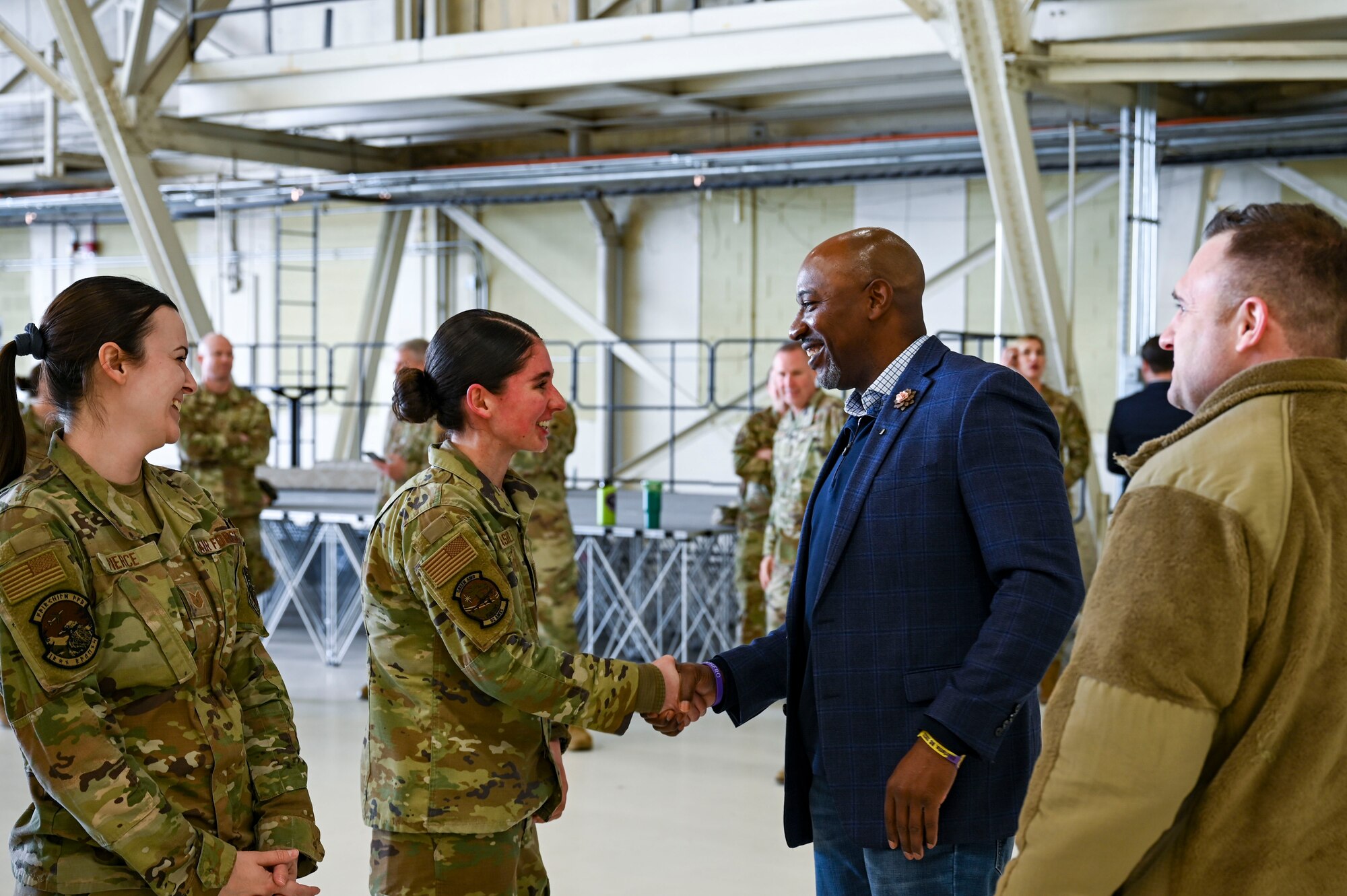 A man and woman shake hands.