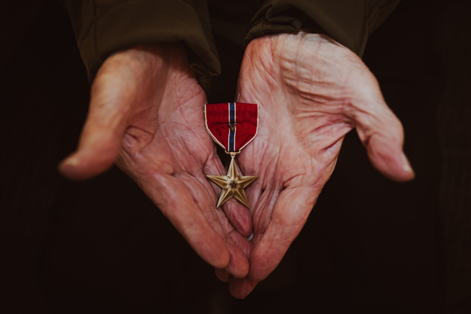 Retired U.S. Marine Corps Staff Sgt. Ismael Gonzalez-Ramos, a former infantry unit leader and decorated combat veteran, holds his Bronze Star medal with a combat action “V” device, an award for valor and heroism in combat, at his home in Jacksonville, North Carolina, Nov. 20, 2023. 92-year-old Gonzales-Ramos was drafted from Cidra, Puerto Rico in 1951 and served in the Korean War and Vietnam War during his 20 years of honorable service in the Marine Corps. (U.S. Marine Corps photo by Lance Cpl. Loriann Dauscher)
