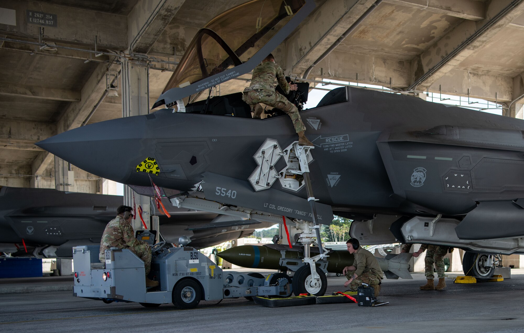 Airmen conduct fighter jet munitions loading.