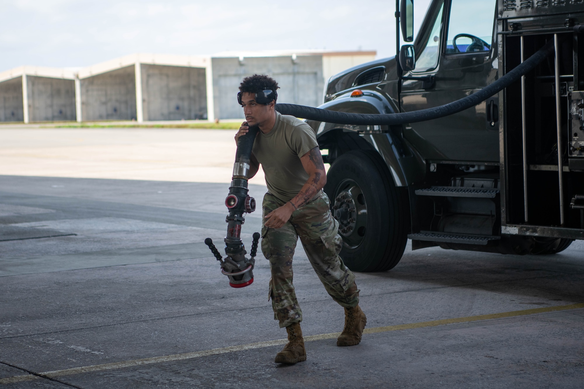 An Airman unravels a hose.