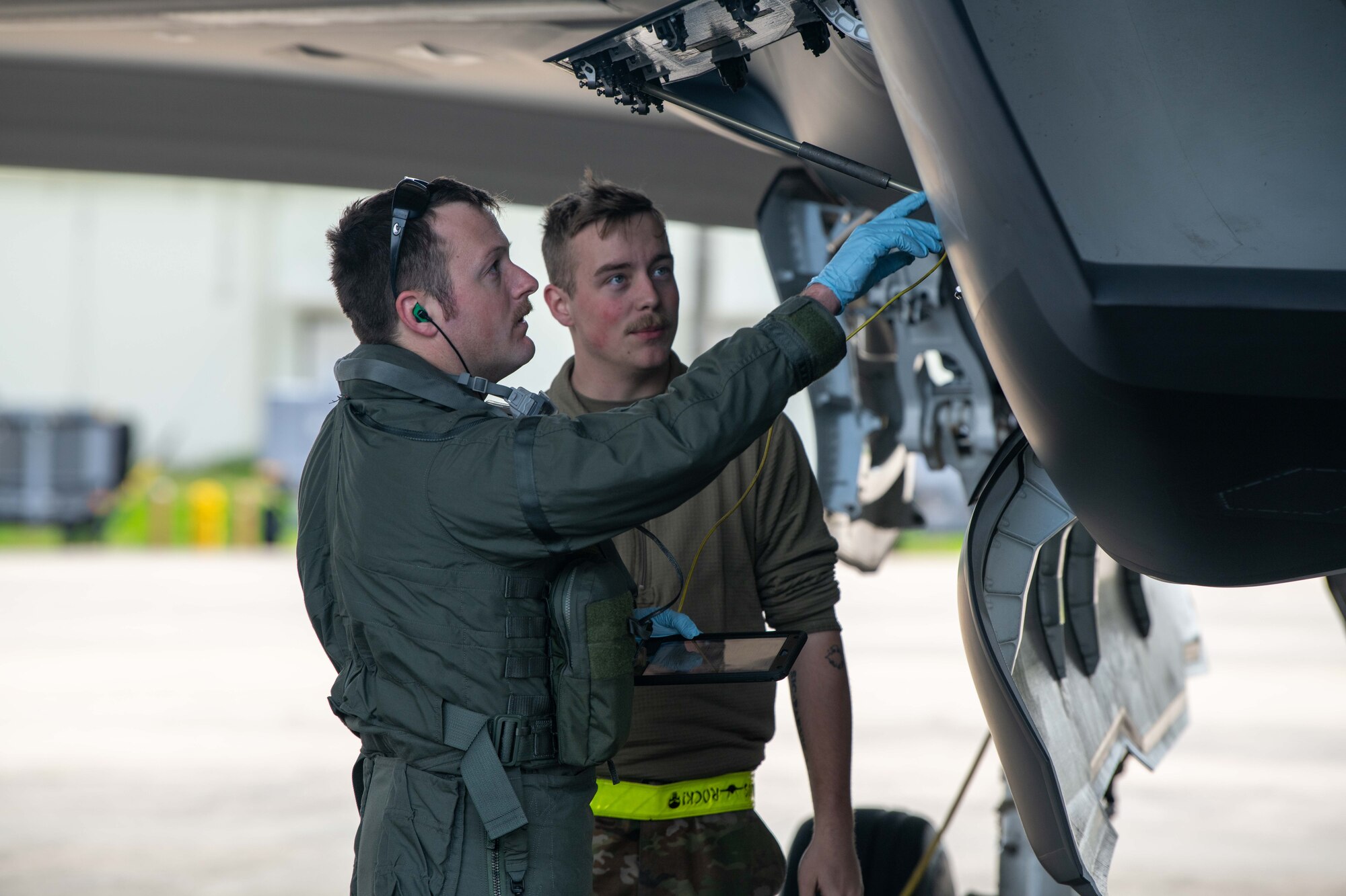 Four Airmen conduct refueling operations.