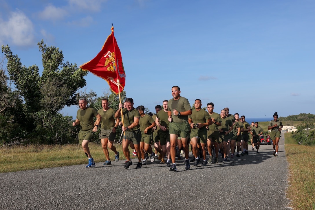 U.S. Marines stationed on Marine Corps Base (MCB) Camp Blaz conduct a unit run lead by Col. Ernest Govea, commanding officer of MCB Camp Blaz (left) and Sgt. Maj. Daniel Soto, the command senior enlisted advisor of MCB Camp Blaz, on Naval Computer and Telecommunications Station, Guam, Feb. 28, 2024. The Marines ran a 4.6 mile route in order to maintain physical readiness, build unit camaraderie and emphasize espirit de corps. (U.S. Marine Corps photo by Lance Cpl. Ryan Little)