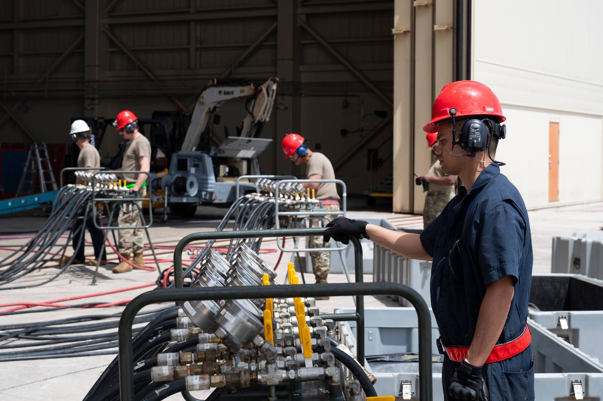 U.S. Air Force Airmen with the 36th Maintenance Squadron monitor pressure manifold modules while using low pressure heavy aircraft lifting bags to lift an A310 aircraft on Andersen Air Force Base, Guam, Feb. 22, 2024. The Airmen had to lift the aircraft so that contractors could use an excavator to demolish it due to unrepairable damages. (U.S. Air Force Photo by Airman 1st Class Spencer Perkins)