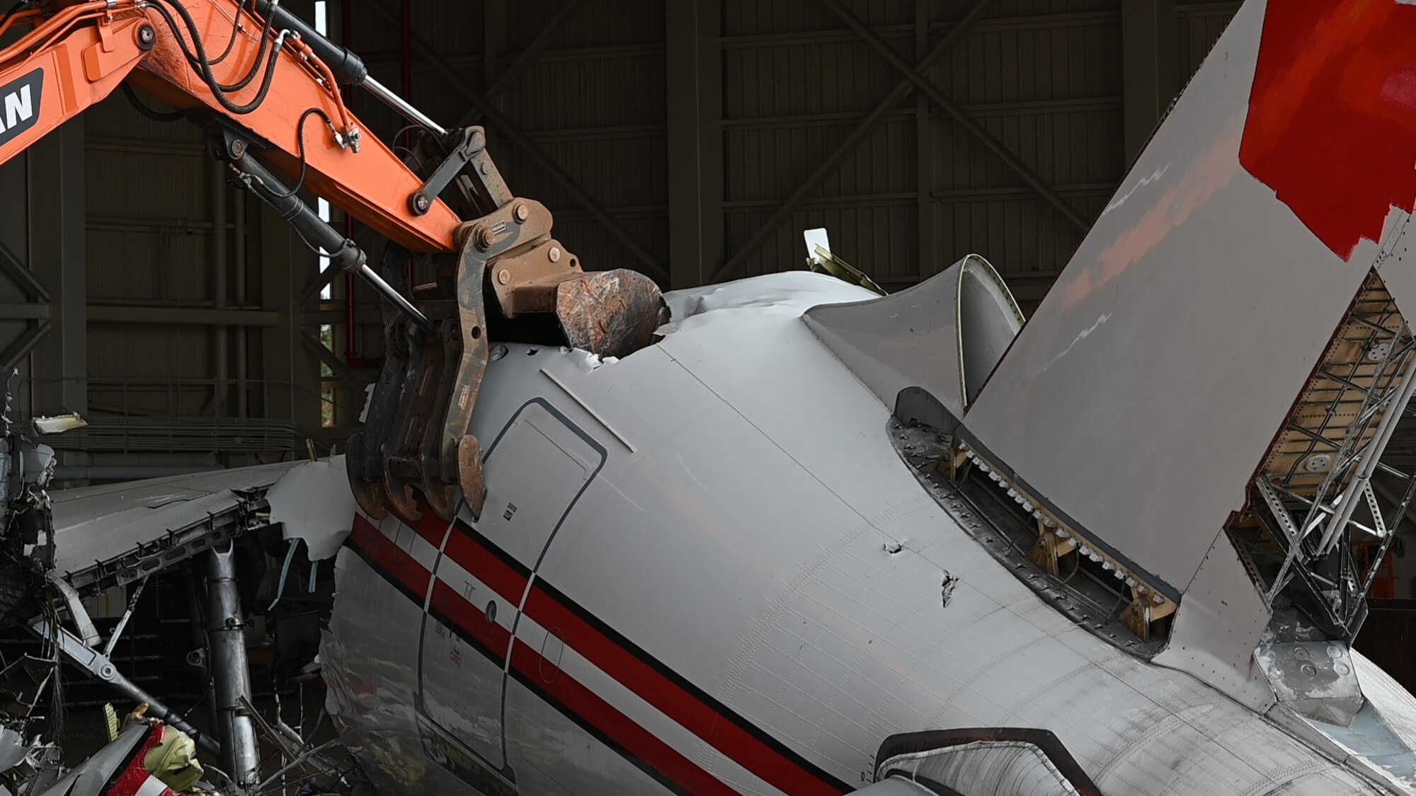Contractors use an excavator to destroy an A310 aircraft on Andersen Air Force Base, Guam, Feb. 23, 2024. The contractors had to demolish the aircraft due to unrepairable damages. (U.S. Air Force photo by Senior Airman Akeem K. Campbell)