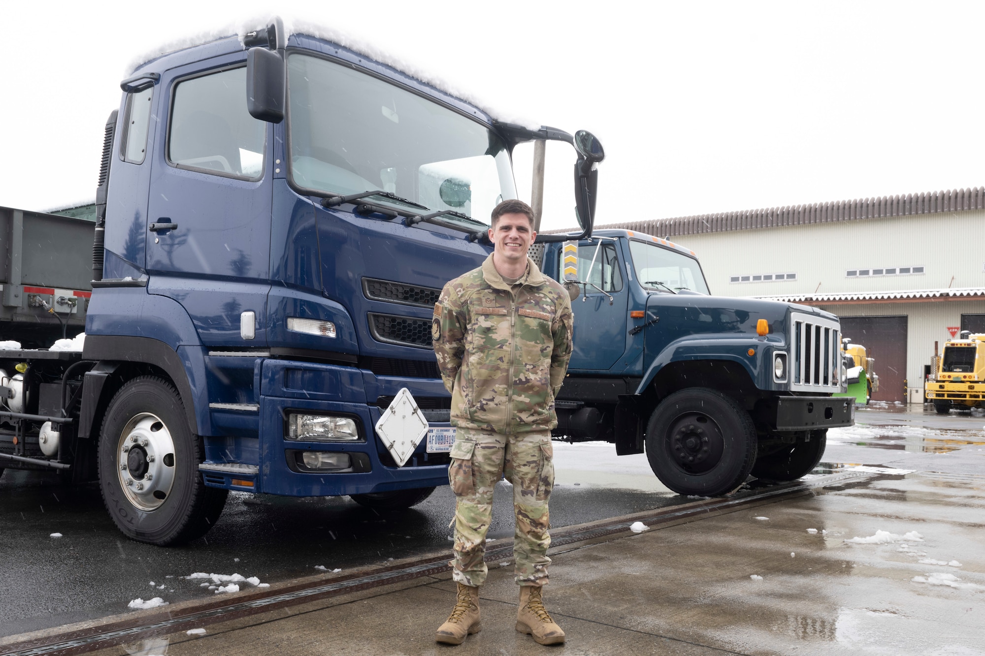 Tech. Sgt. Anthony Dillier, 35th Logistics Readiness Squadron (LRS) ground transportation noncommissioned officer in charge, stands in front of government-owned vehicles used by LRS at Misawa Air Base, Japan, Feb. 26, 2024.