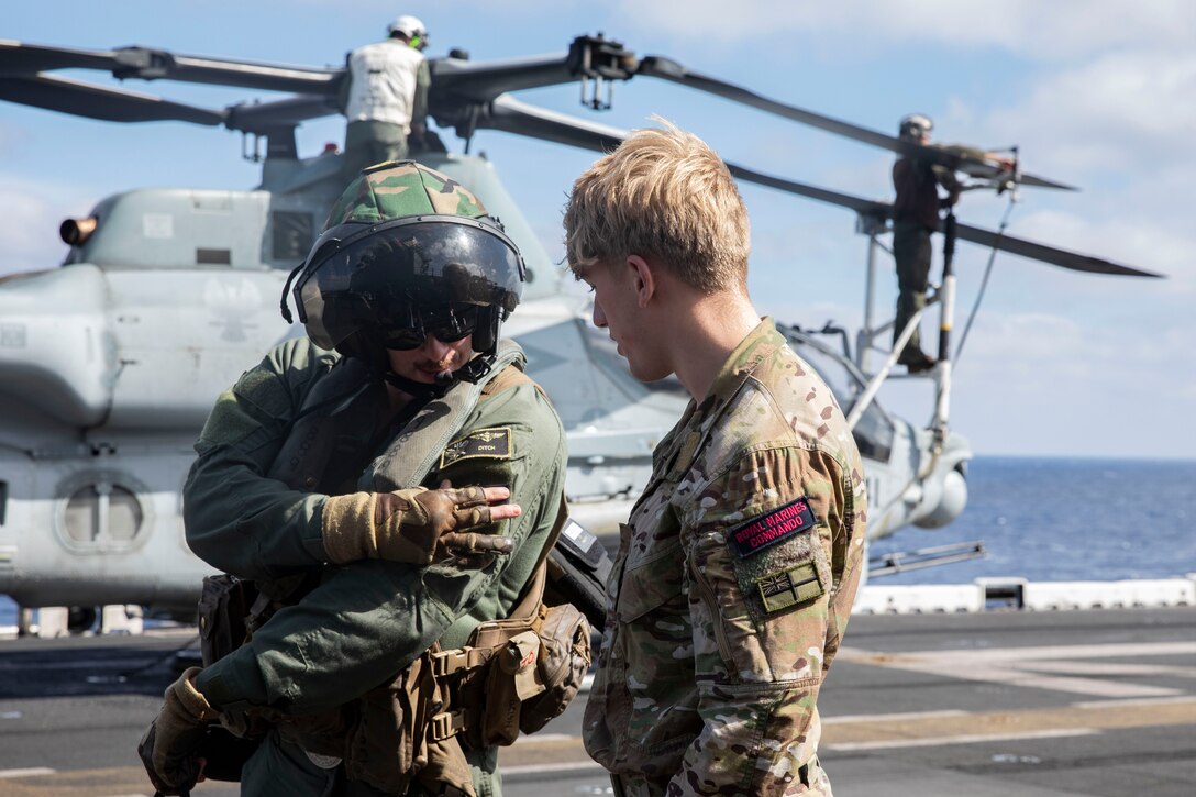 A U.S. Marine with Marine Medium Tiltrotor Squadron (VMM) 162 (Reinforced) trades patches with a British Royal Marine on the flight deck of the Wasp class amphibious assault ship USS Bataan, Feb. 25, 2024. The Bataan Amphibious Ready Group is transferred under NATO command in the Eastern Mediterranean in order to conduct a series of short notice vigilance activities with elements of time Maritime Command’s Standing NATO Maritime Group 2 and the Turkish Navy. (U.S. Marine Corps photo by Cpl. Michele Clarke)