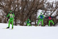 The Washington National Guard men's Patrol Team climbs an incline during the 50th anniversary Chief of the National Guard Bureau Biathlon Championships at Soldier Hollow Nordic Center Feb. 21, 2024. The Utah National Guard hosted the national biathlon competition consisting of cross-country skiing and competitive shooting events that tested the warriors’ endurance and marksmanship.