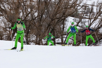 The Washington National Guard men's Patrol Team climbs an incline during the 50th anniversary Chief of the National Guard Bureau Biathlon Championships at Soldier Hollow Nordic Center Feb. 21, 2024. The Utah National Guard hosted the national biathlon competition consisting of cross-country skiing and competitive shooting events that tested the warriors’ endurance and marksmanship.