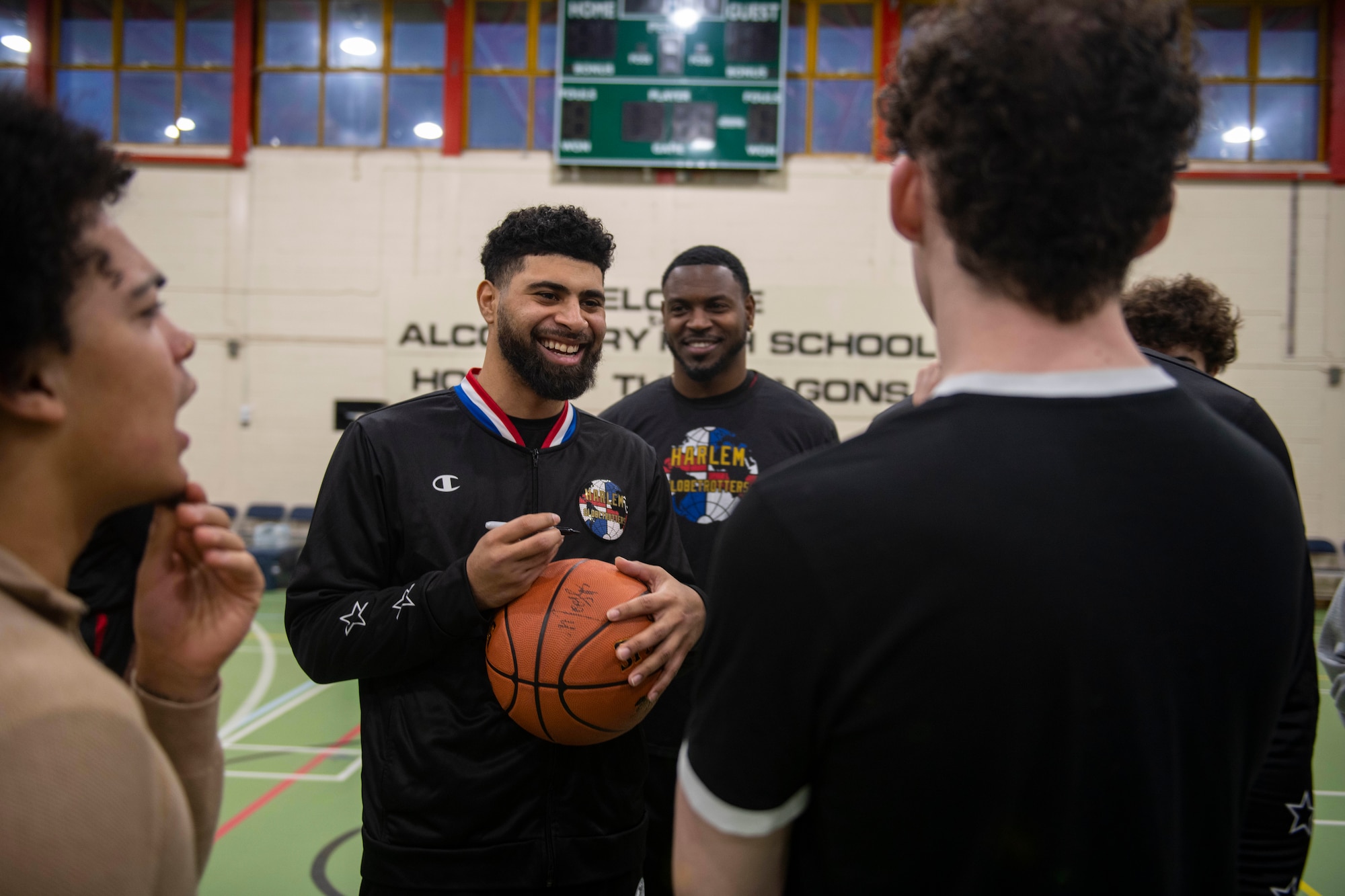 The Harlem Globetrotters meet with basketball players from RAF Alconbury Middle High School at RAF Alconbury