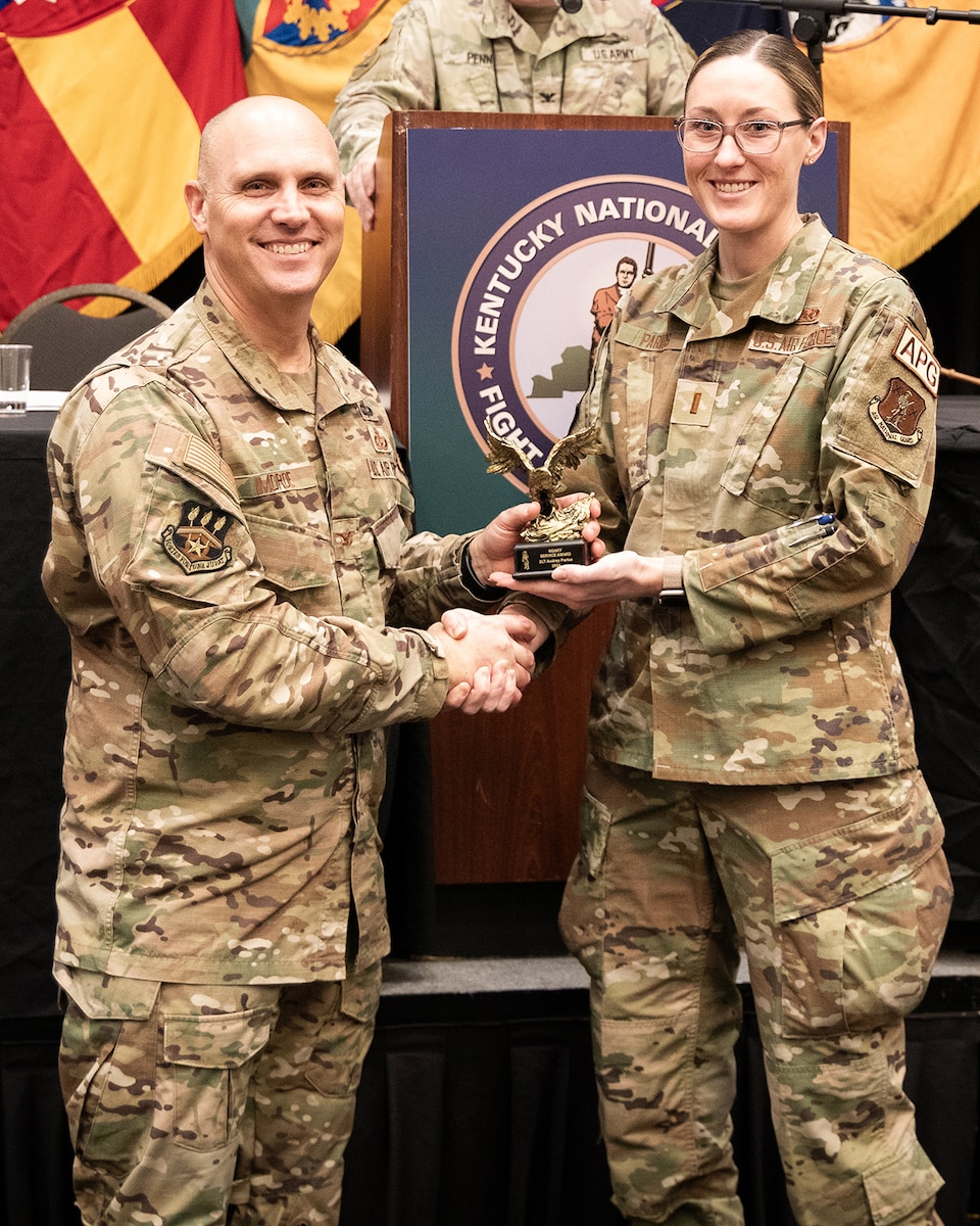 2nd Lt. Audrey Parios, right, of the Kentucky Air National Guard’s 123rd Maintenance Group, receives the National Guard Association of Kentucky’s Service Award from Col. George Imorde, association president, during the organization’s annual conference in Bowling Green, Ky., Feb. 3, 2024. During the Kentucky National Guard’s response to the COVID-19 pandemic, Parios worked seamlessly with military and civilian counterparts to provide more than 53,000 hours of non-clinical services, freeing medical providers to execute crucial patient care. (U.S. Army National Guard photo by Maj. Michael Reinersman)