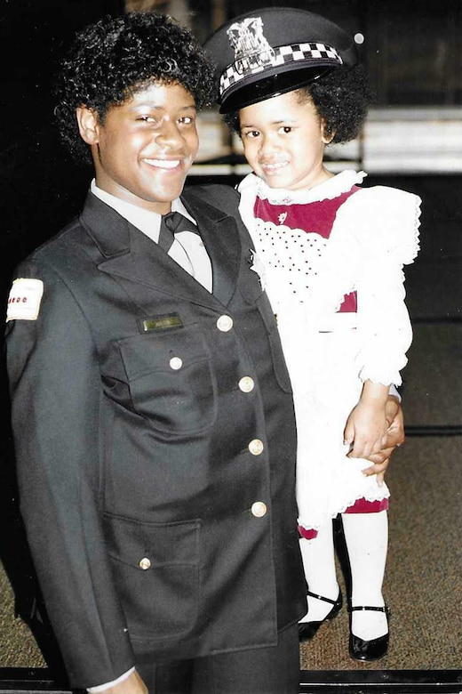 Army Reserve Soldier Diane Mason pauses for a photo in her Chicago Police Department uniform with her daughter. Mason, an 18-year serving Soldier, successfully balanced the demands of being a police officer and Army Reserve Soldier.