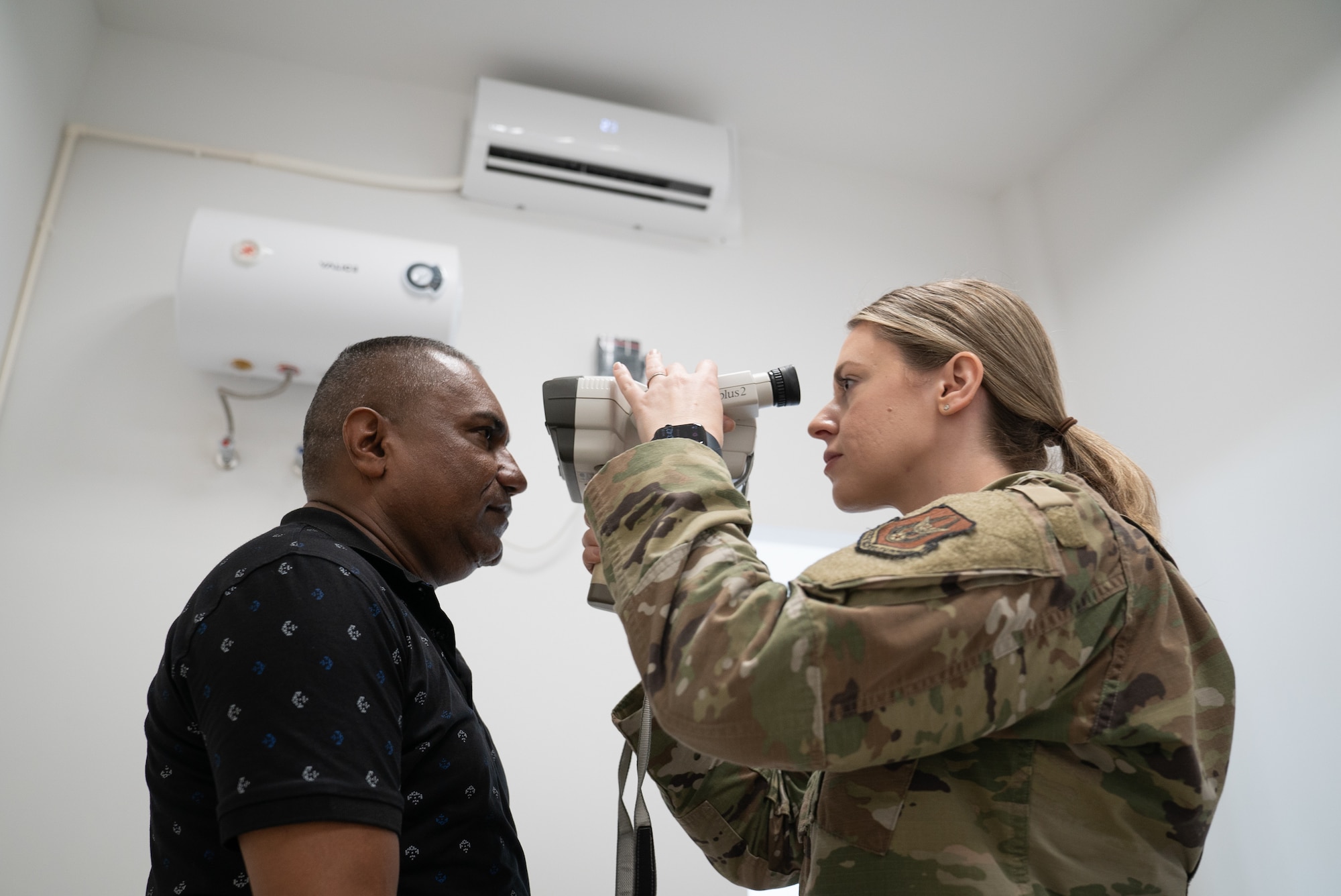 U.S. Air Force Master Sergeant Stacey Kinney, 512th Aerospace Medical Squadron optometry specialist, performs an eye test at Regional Hospital Wanica, Wanica District, during the Lesser Antilles Medical Assistance Team mission in Suriname, Feb. 21, 2024.