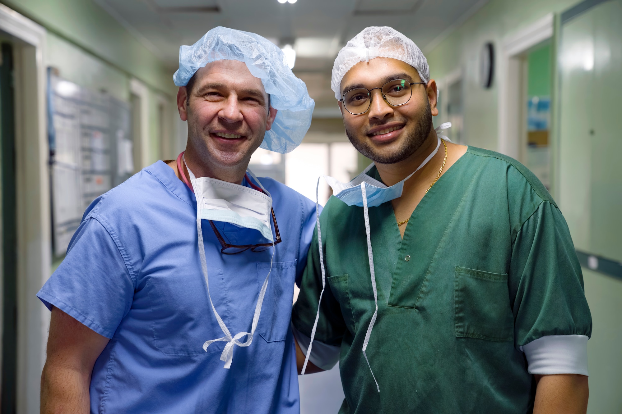 U.S. Air Force reservist Lt. Col. Shea Pribyl, left, general surgeon from the 349th Medical Squadron, and Dr. Kiran Banwari, right, surgery resident, poses for a photo after conducting surgery at Paramaribo’s Academic Hospital during the Lesser Antilles Medical Assistance Team mission  in Suriname, Feb. 21, 2024.