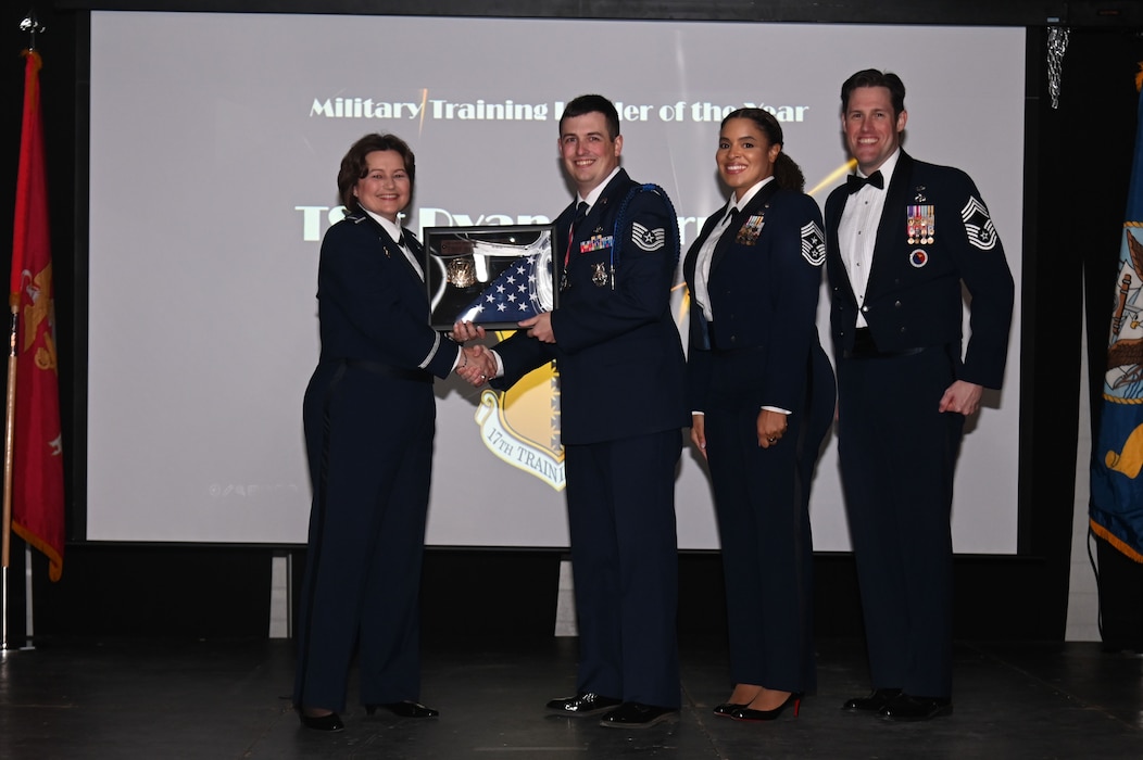 U.S. Air Force Col. Angelina Maguinness presents the Military Training Leader Award to Technical Sgt. Ryan Offerman during the Annual Awards Ceremony at the First Finacial Pavilion, San Angelo, Texas Feb. 24, 2023. The event started with a social hour, followed by a dinner, and finished with announcing the annual award winners. (U.S. Air Force photo by Airman James Salellas)