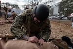 240126-N-KC192-1117 PORTSMOUTH, Va. (Jan. 26, 2024) Hospital Corpsman 3rd Class Ethan Orshanski, a general duty corpsman assigned to Expeditionary Medical Facility (EMF) Juliet, makes an incision on a simulated patient during a Tactical Combat Casualty Care (TCCC) Tier 3 