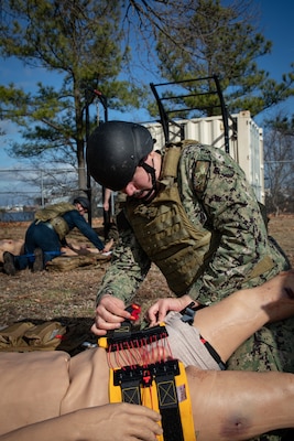 240126-N-KC192-1234 PORTSMOUTH, Va. (Jan. 26, 2024) Hospital Corpsman 3rd Class Christopher Hamm, a general duty corpsman assigned to Expeditionary Medical Facility (EMF) Juliet, applies a pelvic binder to a simulated patient during a Tactical Combat Casualty Care (TCCC) Tier 3 "Train the Trainer" and pilot course on board Naval Support Activity (NSA) Hampton Roads - Portsmouth Annex, Jan. 26, 2024. The two-week course certified 15 TCCC providers that were also able to provide in-depth feedback on course improvements. TCCC Tier 3 is a combat medic course that provides in-depth life saving techniques, technical information and strategies for Department of Defense first responders, and ensures students receive the necessary hands-on training experience that is required for U.S. Navy medical forces to maintain deployment readiness. (U.S. Navy photo by Mass Communication Specialist 2nd Class Levi Decker)