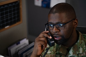 U.S. Air Force Senior Airman Jared Gilbert, a 6th Communications Squadron cyber readiness analyst, answers a phone call at MacDill Air Force Base, Florida, Feb. 28, 2024.