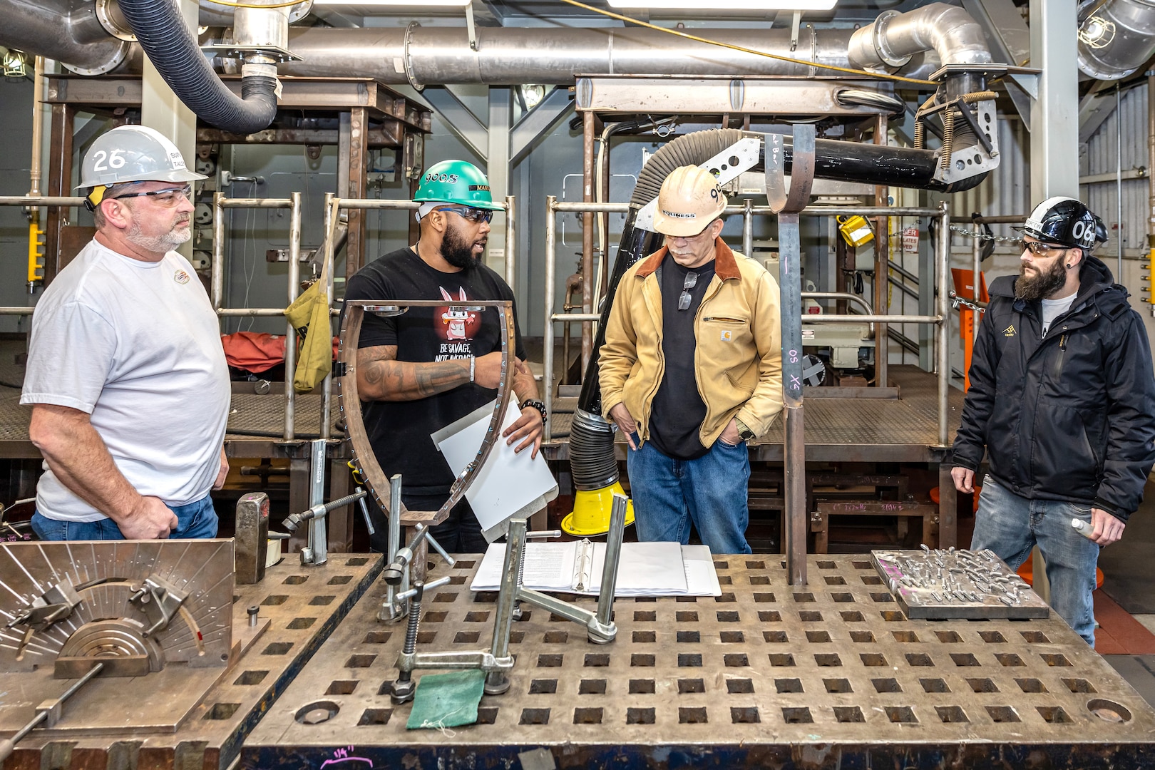 Idrese Manning, middle left, waterfront safety advocate, Code 900S, Waterfront Safety, conducts a "1001 Steps Supervisor/Work Leader Safety Course" for (from left) Rick Tally, supervisor, Shop 26, Welders, Chris Holiness, work leader, Shop 99, Temporary Services, and Andrew Gorton, supervisor, Shop 06, Logistics, Feb. 12, 2024, in Building 460 at Puget Sound Naval Shipyard & Intermediate Maintenance Facility in Bremerton, Washington. (U.S. Navy photo by Jeb Fach)