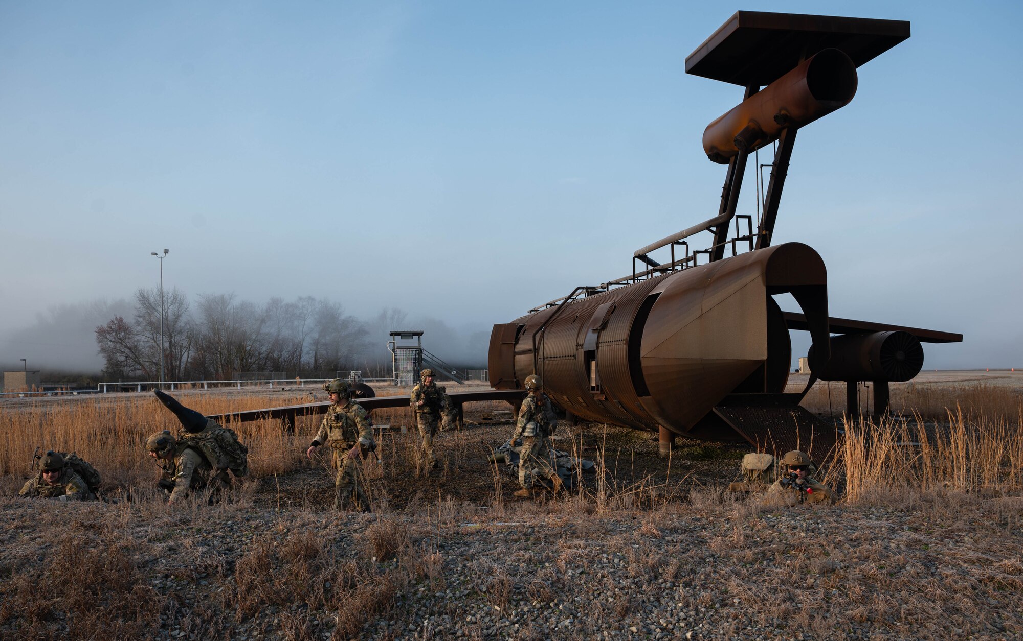 U.S. Airmen assigned to the 4th Civil Engineer Squadron perform a sweep of a downed aircraft and hold security during a simulated response exercise at Seymour Johnson Air Force Base, North Carolina, Feb. 22, 2024. Over the course of the exercise, participants practiced recovering downed pilots, located sensitive components and transported high value explosive items while maintaining security in a simulated hostile environment. (U.S. Air Force Photo by Airman 1st Class Rebecca Sirimarco-Lang)