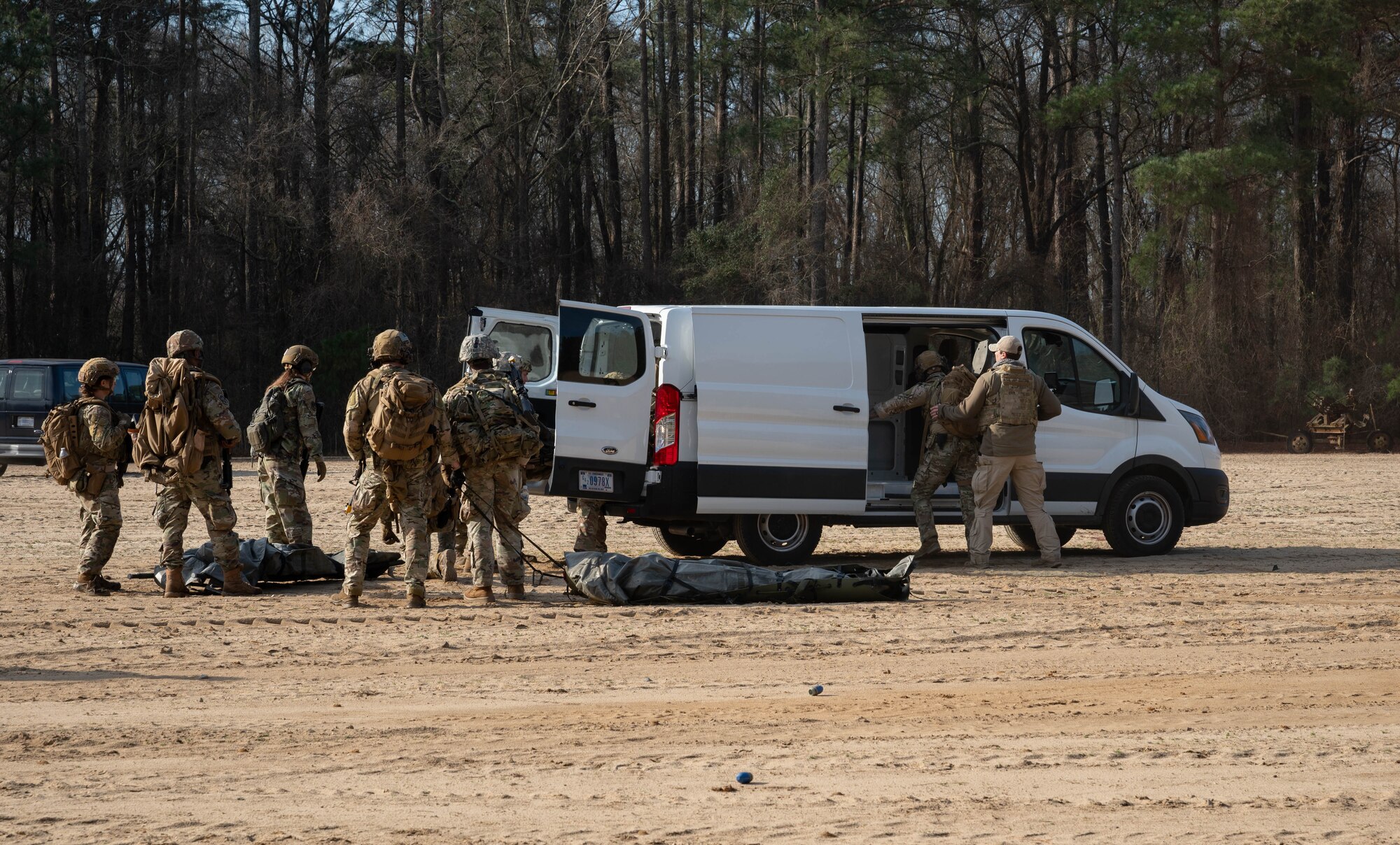 U.S. Airmen assigned to the 4th Civil Engineer Squadron load personnel into a mock helicopter rescue during a simulated response exercise at Seymour Johnson Air Force Base, North Carolina, Feb. 22, 2024. The training tested the squadron’s ability to properly respond to an aircraft crash under strenuous conditions and brought several different organizations across base together to maximize a realistic atmosphere and maintain security. (U.S. Air Force Photo by Airman 1st Class Rebecca Sirimarco-Lang)