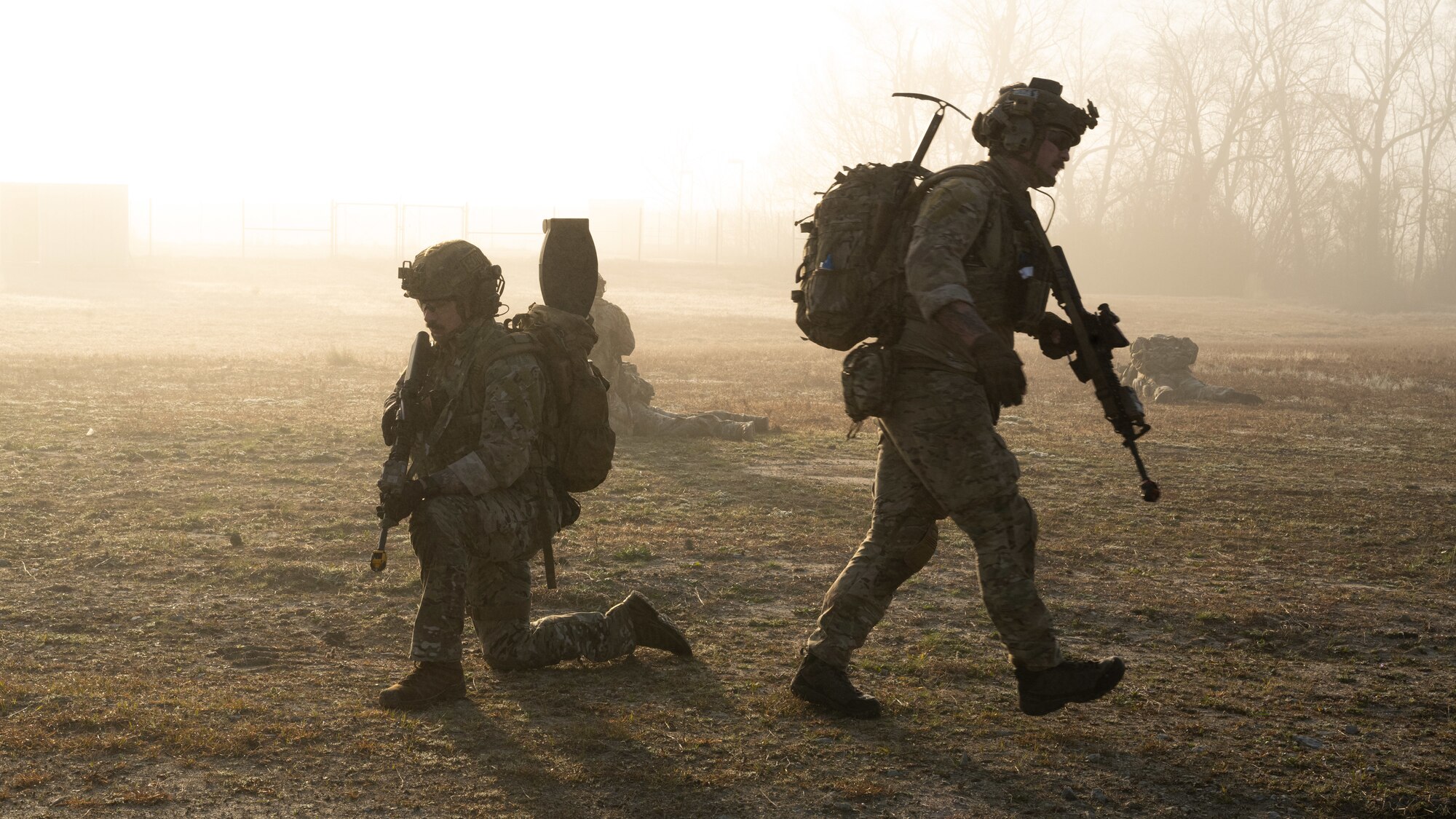 U.S. Air Force Technical Sgt. Adam King, left, an explosive ordnance disposal team member and Staff Sgt. Gabriel Parini, right, an explosive ordnance disposal team lead, both assigned to the 4th Civil Engineer Squadron, conduct tactical maneuvers during a simulated response exercise at Seymour Johnson Air Force Base, North Carolina, Feb. 22, 2024. The training tested the squadron’s ability to properly respond to an aircraft crash under strenuous conditions and brought several different organizations across base together to maximize a realistic atmosphere and maintain security. (U.S. Air Force Photo by Airman Rebecca Tierney)