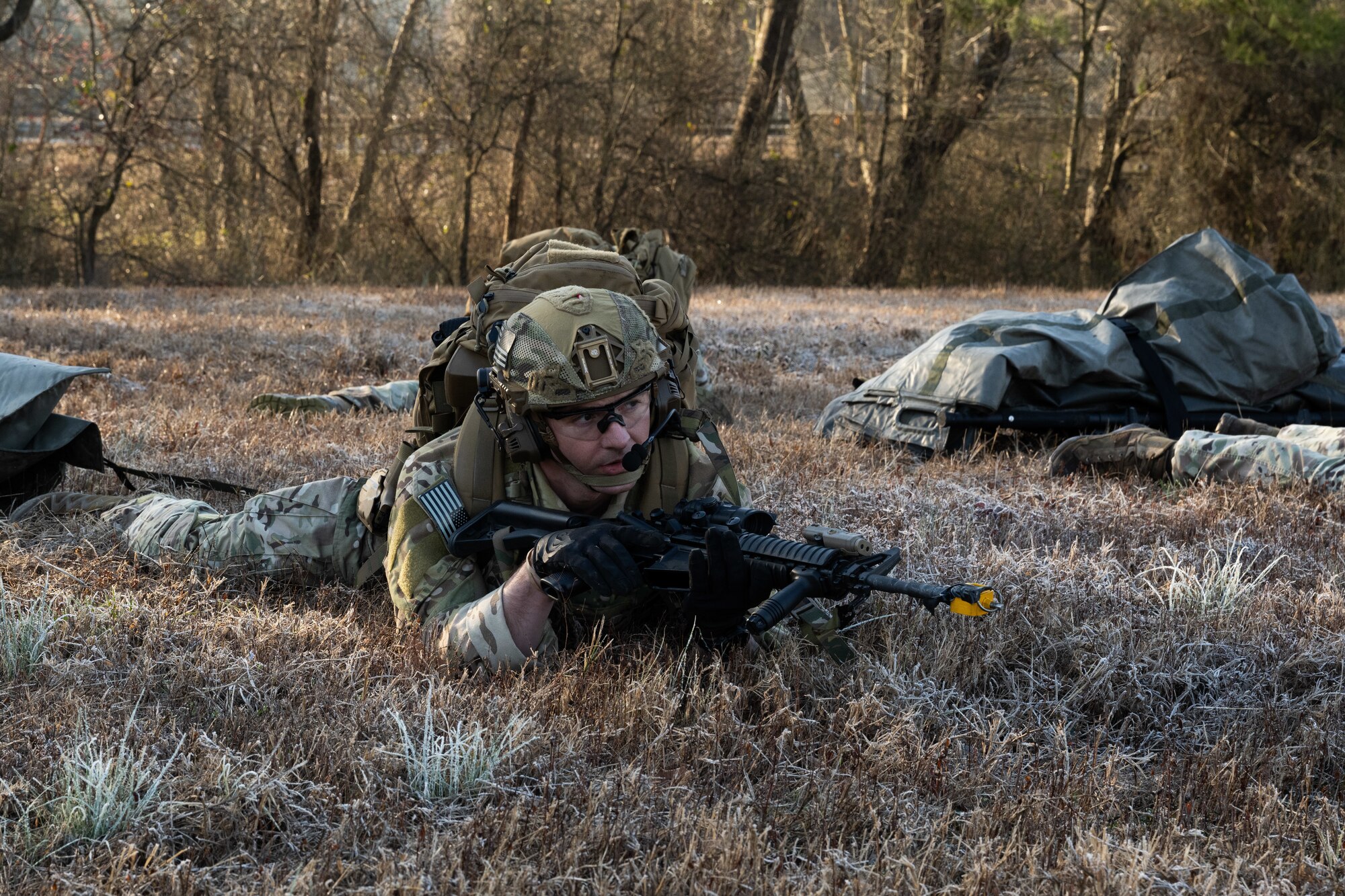 U.S. Air Force Senior Airman Nicholas Farrar, an explosive ordnance disposal team member assigned to the 4th Civil Engineer Squadron, aims an M4 carbine during a simulated response exercise at Seymour Johnson Air Force Base, North Carolina, Feb. 22, 2024. Over the course of the exercise, participants practiced recovering downed pilots, located sensitive components and transported high value explosive items while maintaining security in a hostile environment. (U.S. Air Force Photo by Airman Rebecca Tierney)