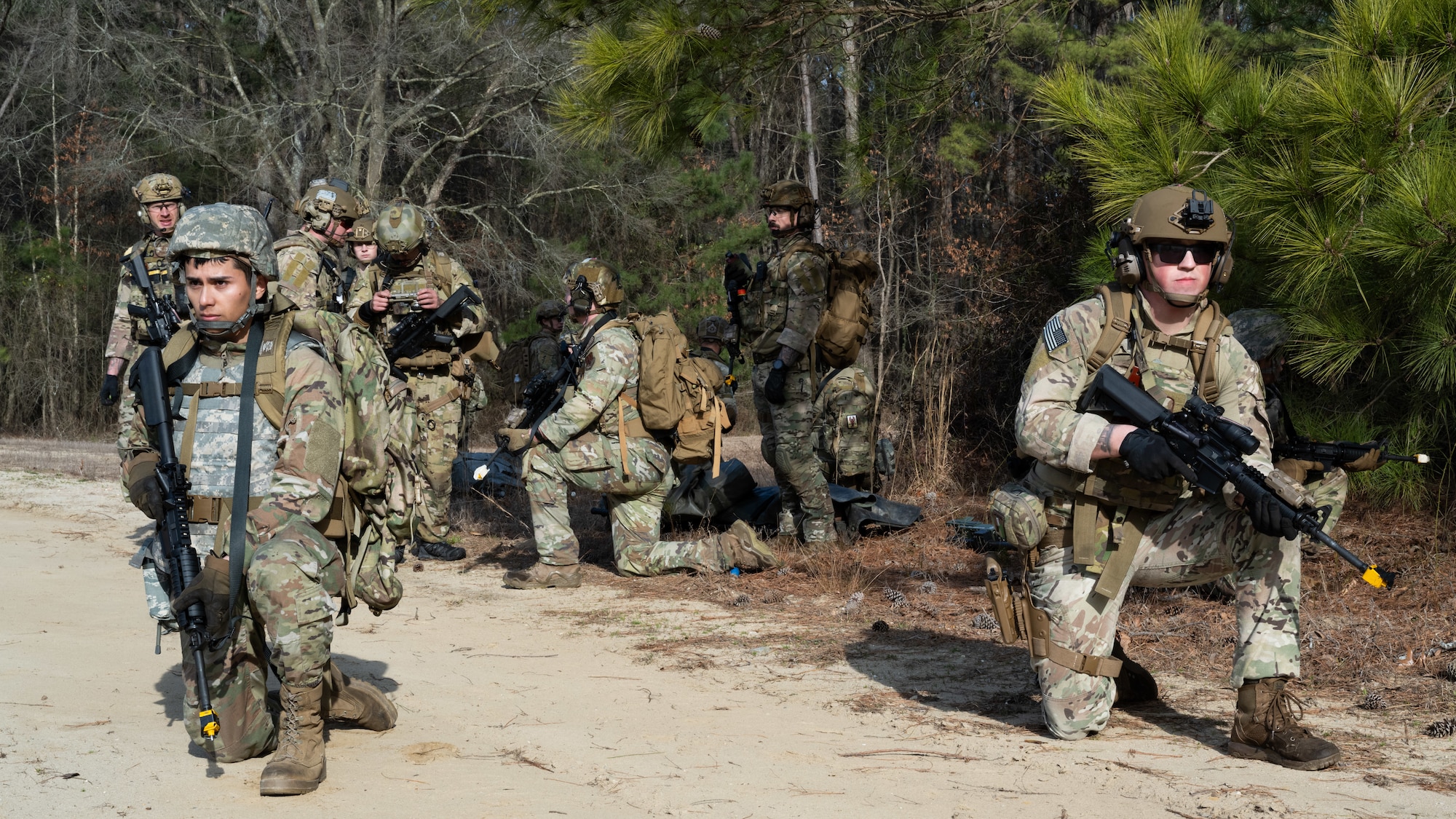 U.S. Airmen assigned to the 4th Civil Engineer Squadron conduct fire team maneuvers during a simulated response exercise at Seymour Johnson Air Force Base, North Carolina, Feb. 22, 2024. Over the course of the exercise, participants practiced recovering downed pilots, located sensitive components and transported high value explosive items while maintaining security in a hostile environment. (U.S. Air Force Photo by Airman Rebecca Tierney)