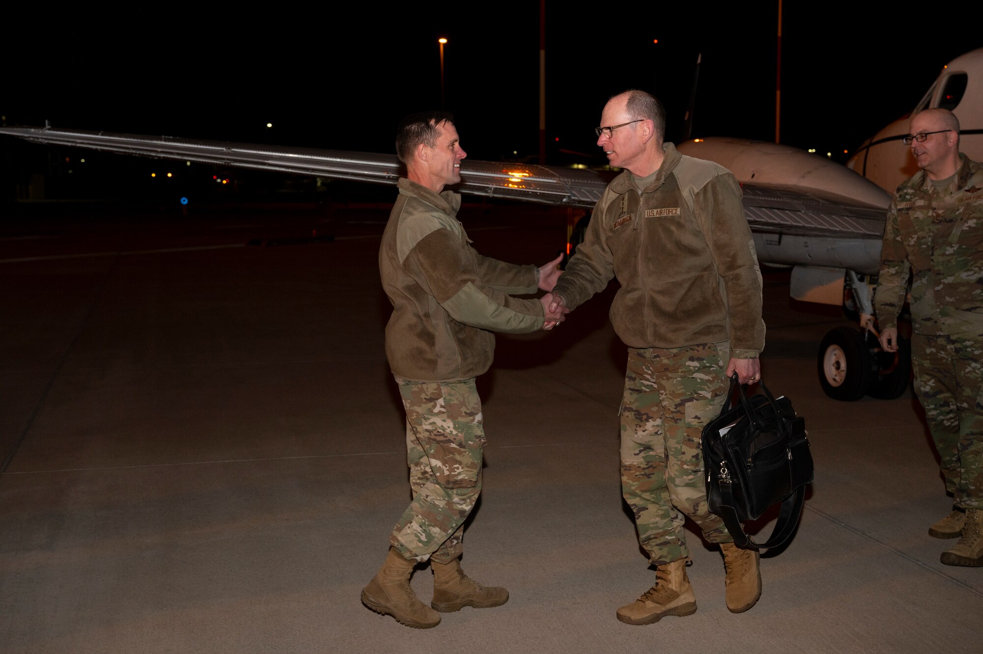 Man shakes another man's hand.