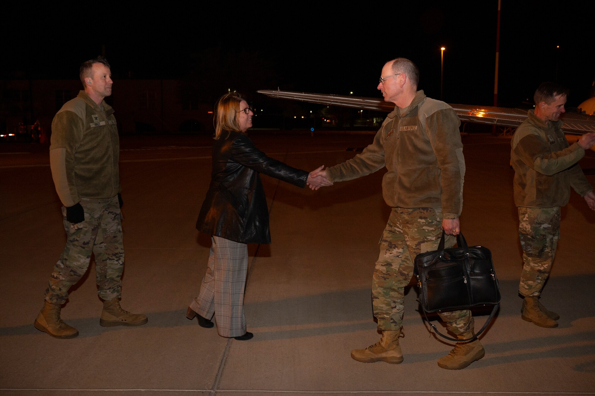 Man shakes woman's hand.