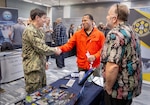 Capt. JD Crinklaw, commander, Puget Sound Naval Shipyard & Intermediate Maintenance Facility, shakes hands with Dwight Stephens, a job applicant from Bremerton, Washington, Feb. 23, 2024, during a two-day PSNS & IMF Hiring Fair at the Kitsap Conference Center in downtown Bremerton. (U.S Navy photo by Wendy Hallmark)