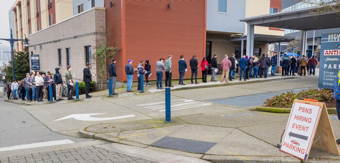 Hundreds of job seekers line the streets outside the Kitsap Conference Center, Feb. 23, 2024, as they wait to enter the Puget Sound Naval Shipyard & Intermediate Maintenance Facility Hiring Fair in downtown Bremerton, Washington. (U.S Navy photo by Wendy Hallmark)