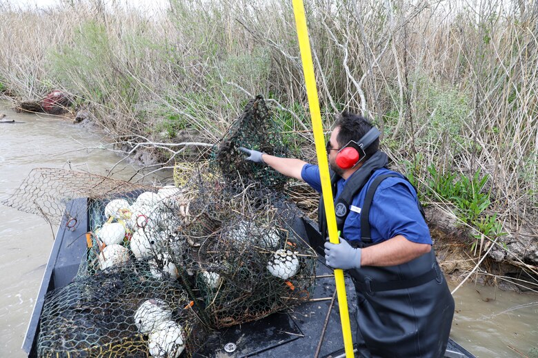 Each year, the Texas Parks and Wildlife Division (TPWD) closes crab fishing with wire mesh crab traps for ten days to give volunteers the opportunity to round up lost and abandoned traps. The closure is traditionally in late February or early March. Unattended traps “ghost fish” and kill blue crabs and other species unnecessarily and can also create a navigation hazard for boaters.
According to a press release from TPWD, since the “Crab Trap Roundup” began 22 years ago, volunteers have removed 42,500 derelict traps, saving an estimated 700,000 blue crabs, a valuable natural resource.
Each year at the Wallisville Lake Project, U.S. Army Corps of Engineers (USACE), Galveston District (SWG) personnel join the Crab Trap Roundup, while they patrol.