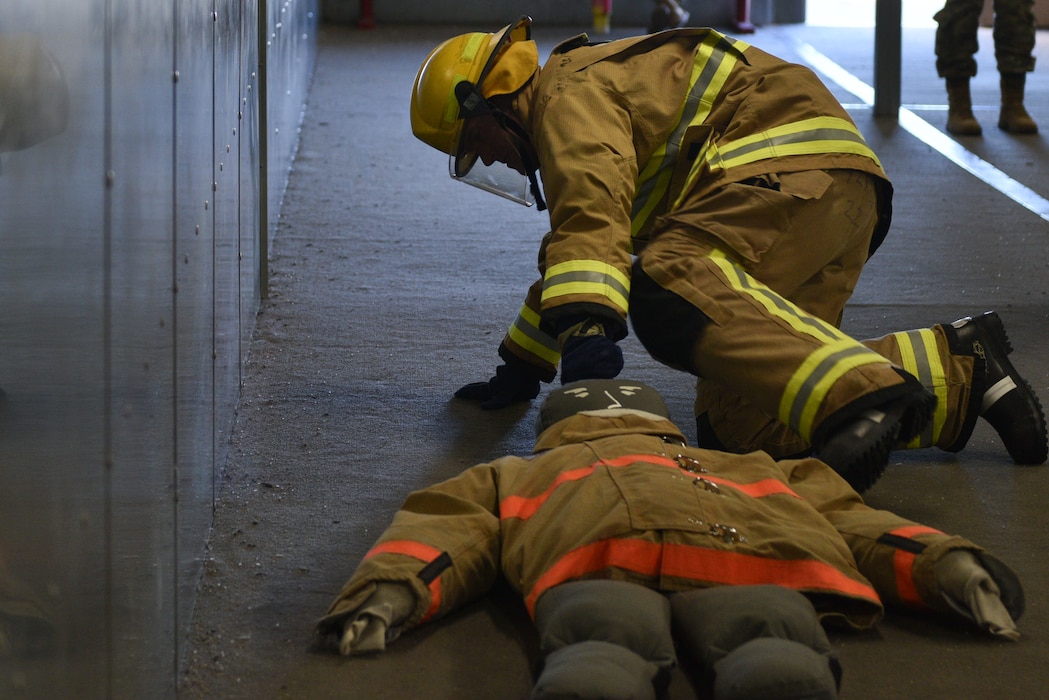 U.S. Air Force Chief Master Sgt. Alex J. Eudy, Senior Non-Commissioned Officer Academy commandant, attempts the fireman's drag to simulate saving a victim from a burning building at Goodfellow Air Force Base, Texas, Feb. 22, 2024. The fireman's drag is one of five techniques used to pull victims to safety. (U.S. Air Force photo by 2nd Lt. Kayunna Holt)
