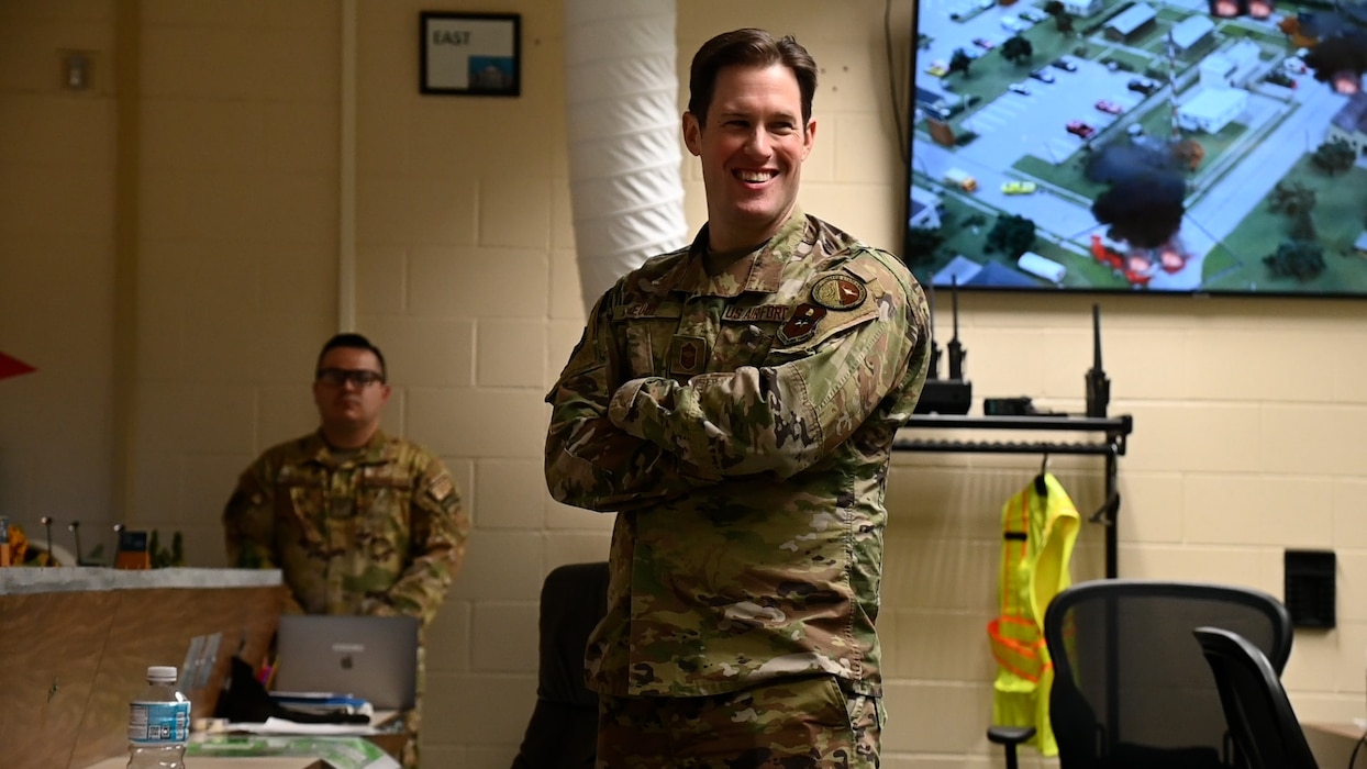 U.S. Air Force Chief Master Sgt. Alex J. Eudy, Senior Non-Commissioned Officer Academy commandant, receives a brief on emergency response procedures through a simulation from Airmen assigned to the 312th Training Squadron at the Louis F. Garland Department of Defense Fire Academy, Goodfellow Air Force Base, Texas, Feb. 22, 2024. Originally built as Flamoke Air Force Base, the Norma Brown Air Force Base trainer is a tabletop-style model used by instructors to help students experience an immersive learning environment.  

(U.S. Air Force photo by Airman James Salellas)