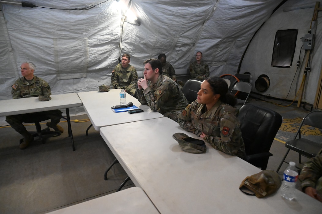 U.S. Air Force Chief Master Sgt. Alex J. Eudy, Senior Non-Commissioned Officer Academy commandant, receives a brief on Forward Operating Base Sentinal and Joint All Domain Excercise Forward, Operation Readiness Generation Excercise training operations at Goodfellow Air Force Base, Texas, Feb. 22, 2024. JADE FORGE provides a variety of training scenarios to prepare students for real-world scenarios. (U.S. Air Force photo by Airman James Salellas)