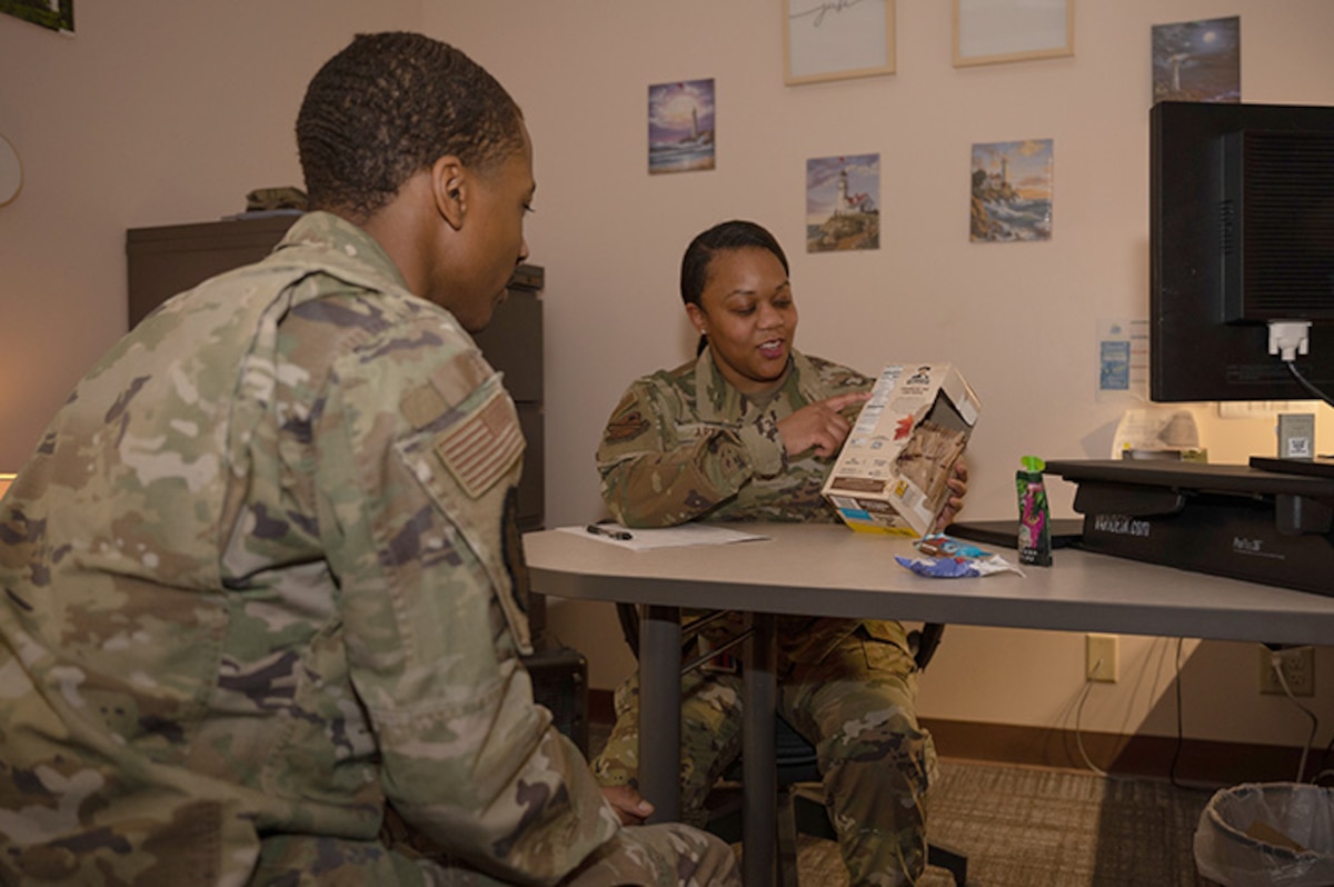 U.S. Air Force Chief Master Sgt. Vanessa Arthur, 354th Medical Group Senior Enlisted Leader, a dietitian by trade, discusses healthier food options with Senior Airman Sekou Williams on Eielson Air Force Base, Alaska, Feb. 27, 2024.
