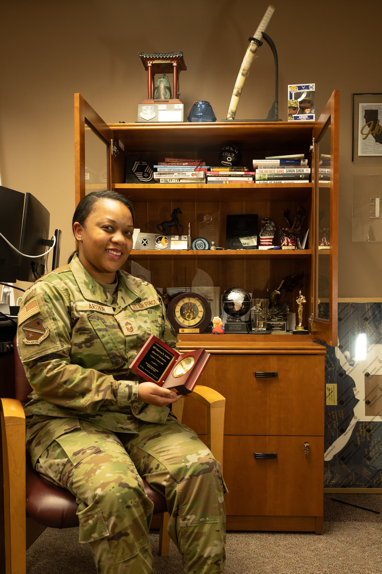 U.S. Air Force Chief Master Sgt. Vanessa Arthur, 354th Medical Group Senior Enlisted Leader, poses in front of her awards on Eielson Air Force Base, Alaska, Feb. 27, 2024.