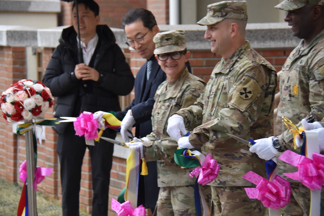 Col. Heather Levy, U.S. Army Corps of Engineers – Far East District commander, joins representatives from the 19th Expeditionary Sustainment Command, 8th Army, U.S. Army Garrison – Daegu and the first family to live in a new housing tower in cutting the ribbon on the facility in a ceremony at Camp Walker, South Korea, on Feb. 29, 2024.