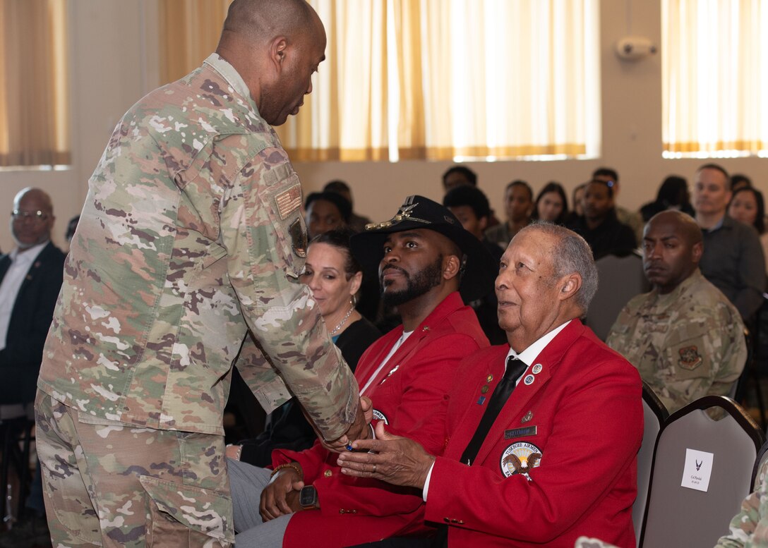 U.S. Air Force Col. Todd E. Randolph, left, 316th Wing and installation commander, presents a memento to retired U.S. Air Force Chief Master Sgt. Frank Killebrew at the Black History Month celebration at Joint Base Andrews