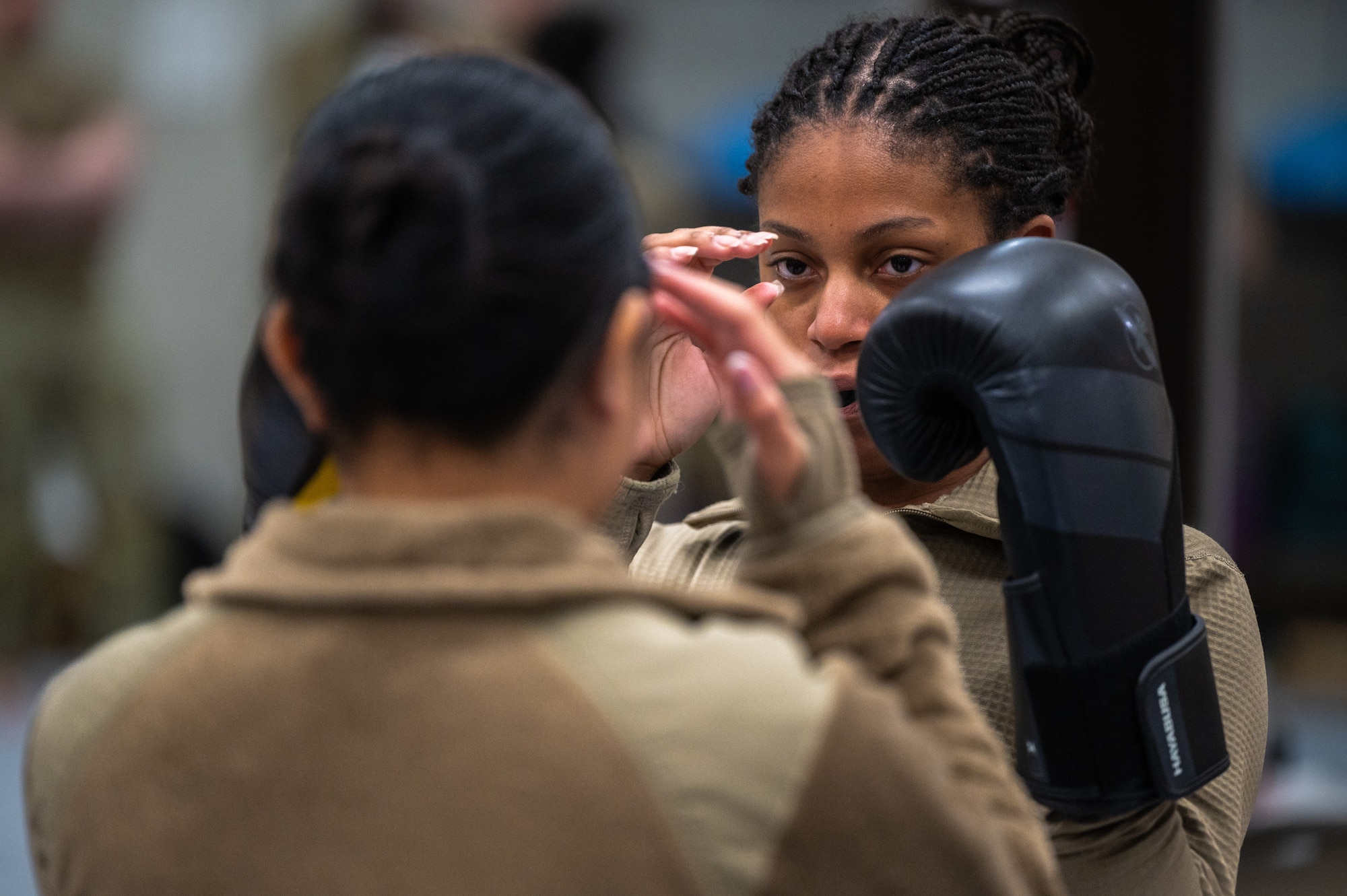 U.S. Air Force Senior Airman Jeanette Casiano, 621st Air Control Squadron weapons director, left, and Senior Airman Breyon Kamoze, 621st ACS battle management operator, participate in a training exercise together during a combatives instructor certification course at Osan Air Base, Republic of Korea, Feb. 23, 2024. The 621st ACS intends to utilize this skill for the operational needs of their unit. They are also capable of instructing members from the 51st Fighter Wing at a later date. The 621st ACS impacts the “Fight Tonight” mission by supporting training and contingency operations of the 51st Fighter Wing, providing lethal tactical battle management for the Air Component Commander during armistice and war. (U.S. Air Force photo by Airman 1st Class Chase Verzaal)