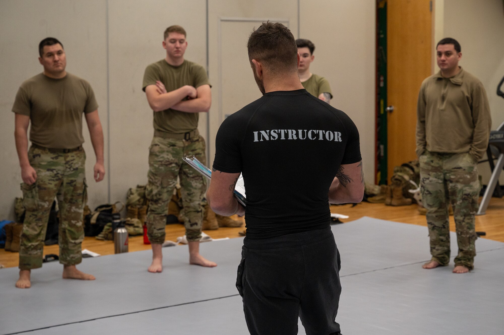 U.S. Air Force Staff Sgt. Kyle Virgillio, 5th Combat Communications Support Squadron master combatives instructor, reviews course material with Airmen from the 621st Air Control Squadron during a combatives instructor certification course at Osan Air Base, Republic of Korea, Feb. 23, 2024. Airmen benefit in many ways from learning combative techniques such as being able to defend themselves and maintaining their physical fitness. The 621st ACS and 607th Air Operations Center intend to utilize the new certifications to tailor a combatives program to their operational needs and enhance their ability to support the 51st Fighter Wing’s combat lethality. (U.S. Air Force photo by Airman 1st Class Chase Verzaal)