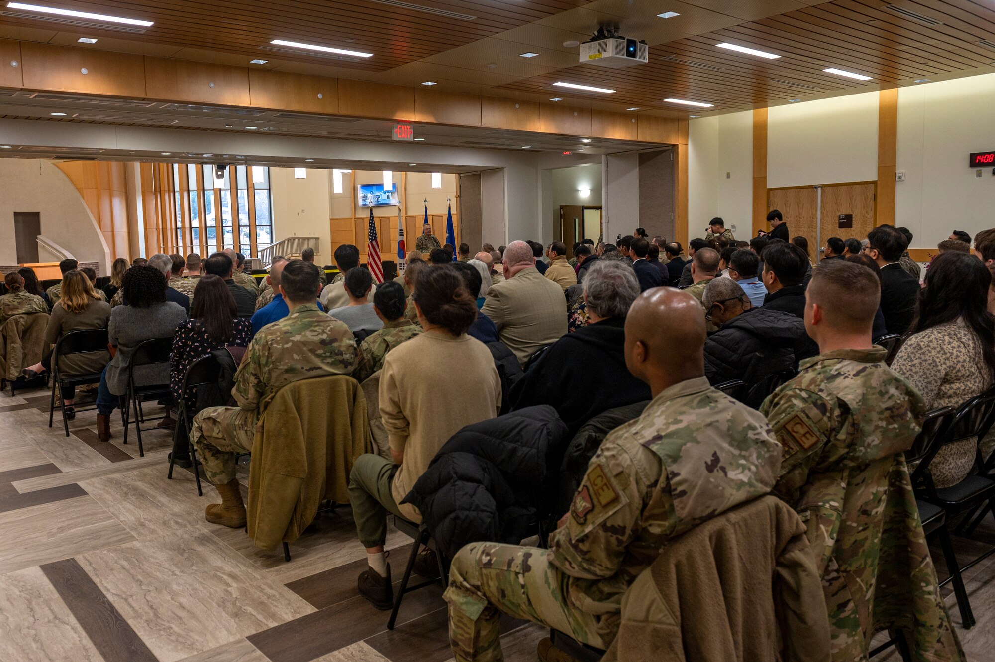 Service members listen to a speech during the Osan Air Base Chapel Grand Opening Ceremony at Osan AB, Republic of Korea, Feb. 29, 2024. The project was programmed 24 years ago and funded three years ago for $15 million, with the assistance from the ROK. The new chapel commits to maintaining its service to Airmen for the next 50 years, demonstrating an investment in Osan today for the Airmen of tomorrow.  (U.S. Air Force photo by Senior Airman Kaitlin Castillo)