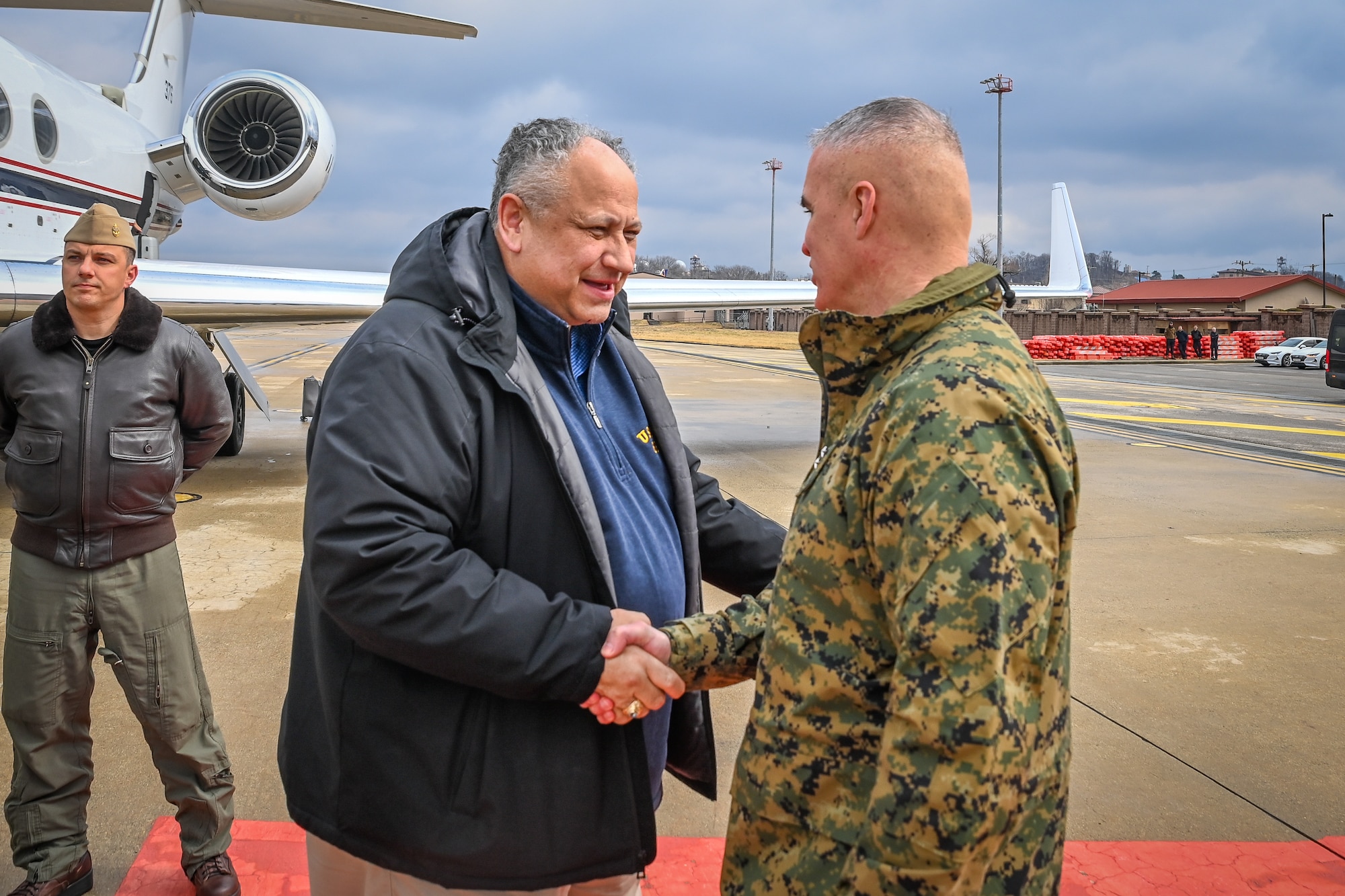 U.S. Marine Corps Maj. Gen. William E. Souza III, Commander, U.S. Marine Forces Korea, right, greets Carlos Del Toro, Secretary of the Navy, during a visit to Osan Air Base, Feb. 25, 2024.