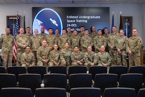 A group of people wearing U.S. Air Force uniforms in a room.