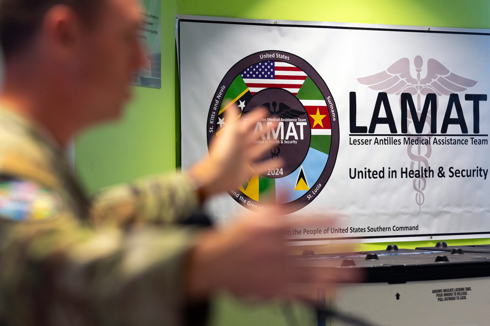 A banner is displayed during a closing ceremony for the Lesser Antilles Medical Assistance Team mission at the Academic Hospital in Suriname, Feb. 28, 2024. LAMAT stands as a symbol of partnership through medical readiness, offering real-world benefits to achieve positive outcomes through collaboration with partner nations. (U.S. Air Force photo by Tech. Sgt. Rachel Maxwell)