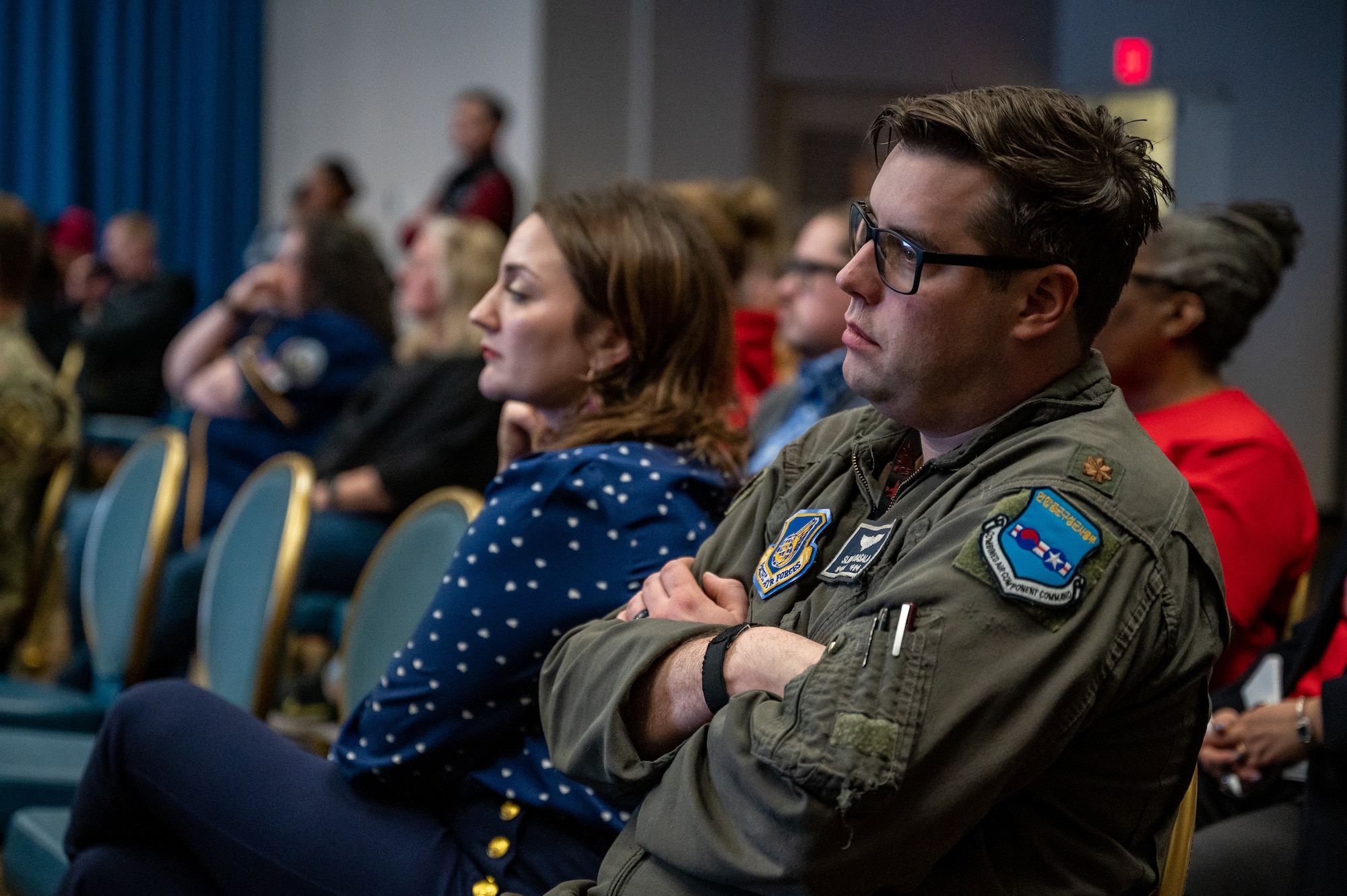 U.S. Air Force Maj. Joseph Basala, 7th Air Force deputy director of the commander’s action group, listens to a brief during a town hall at Osan Air Base, Republic of Korea, Feb. 15, 2024. At the town hall, the 51st Fighter Wing command team debuted the command’s new Communication Action Plan. As part of the plan, the 51st FW introduced the Mustang One-Stop, a user-friendly digital repository for all base information, aimed at simplifying access for Airmen and their families, while also launching monthly town halls to ensure the community remains well-informed and engaged. (U.S. Air Force photo by Staff Sgt. Thomas Sjoberg)