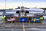 Air Force Airmen assigned to the 28th Bomb Wing, Ellsworth Air Force Base, South Dakota, pose for a group photo alongside Swedish military personnel in front of a B-1B Lancer and two Saab JAS 39 Gripens at Luleå-Kallax Air Base, Sweden, Feb. 26, 2024, during Bomber Task Force 24-2.